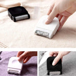 Portable lint remover with ergonomic grip, shown on a fabric surface.