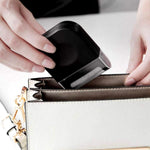 Handheld fabric shaver removing lint from a grey sweater.