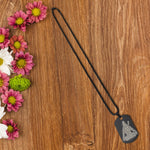 Mahadev Locket in stainless steel with intricate Shiva names engraving, displayed on a dark background.