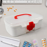 The white First Aid Box open, revealing three organised compartments and a detachable tray.