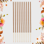 Ten brown incense sticks with light brown tips arranged vertically on a light grey background with floral borders.