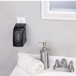 Mini plug-in heater securely plugged into a wall socket for instant heat.