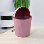 Close-up of mini tabletop dustbin with easy-to-use swing lid