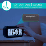A hand pressing the snooze/light button on a black digital alarm clock in a dark room, with text indicating a 5-second soft
