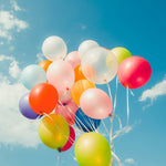 A festive display of multicolored latex balloons for a birthday party.