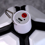 Close-up of the white top of the lantern showing a red power button, a 5V USB port, and a metal hook.