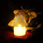 Set of 12 battery operated LED tealight candles with decorative golden net covers