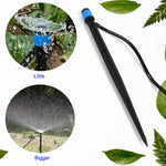 A black and blue water dripper with a thin black hose, surrounded by green leaves, with two circular insets showing – view 3