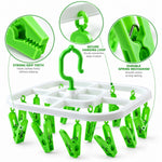 Close-up view of the white and green drying rack highlighting its strong grip teeth and spring mechanism.