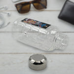 Transparent plastic mukhwas bottle with steel cap on white background