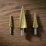 The full set of titanium coated HSS steel step drill bits, ready for various tasks.