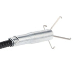 User demonstrating the flexible drain cleaning brush in a kitchen sink.