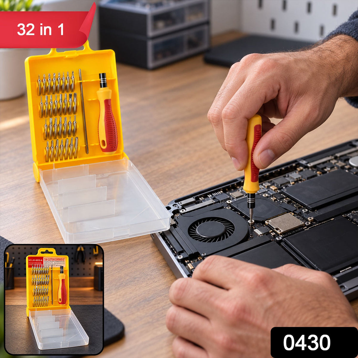 A person uses a yellow and red screwdriver from a 32-piece set to repair a laptop on a wooden desk, with a '32 in 1' label.
