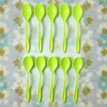A single reusable plastic spoon placed elegantly on a table setting.