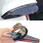 A white car's side mirror with a dark grey rain protector covered in water droplets.