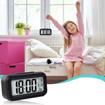A black digital alarm clock displaying 8:30 AM on a windowsill, with a child stretching in bed, and an inset showing the