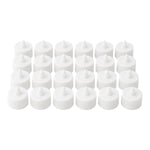 Multiple battery-operated tealights illuminating a dark room.