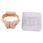 The peach-colored broom holder and a clear self-adhesive hook are presented side-by-side on a white background.