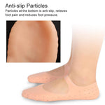 A person wearing peach silicone heel socks, with an inset showing the anti-slip particles on the bottom.