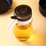 650ml plastic oil dispenser with sleek design for kitchen use.
