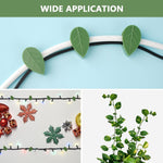 Self-adhesive plant clips discreetly holding a vibrant green vine against a light-coloured wall.