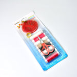 A clear plastic-packaged sewing kit containing thread, a thimble, scissors, and a needle holder.