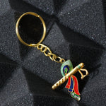 Close-up of Krishna metal keychain featuring flute and peacock feather motif