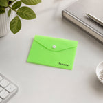 A closed neon green plastic document folder with a white button closure and "Tramix" printed on it, sits on a white desk