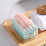 Portable detergent bar holder with a built-in roller brush, ideal for travel.
