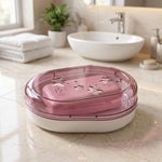 Pink bar of soap inside the closed pink butterfly-patterned soap case on a marble counter in a bathroom setting.