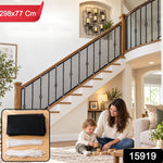 A black mesh safety net is installed on a wooden and iron staircase railing, with a woman and child playing on the – view 2