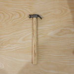 Person using claw hammer to drive a nail in carpentry