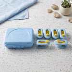A light blue plastic storage case and six blue and yellow plastic clips are arranged on a speckled white countertop next to
