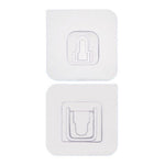 Two white no-drill adhesive hooks mounted on a smooth, clean wall surface.