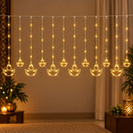 Warm white LED curtain light with twelve hanging diya shapes