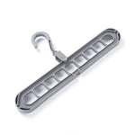 Several shirts and trousers neatly hung on the innovative 9-hole space saving hanger.