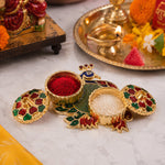 Close-up of ornate peacock kumkum holder design with stones