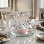 Close-up of faceted crystal swan pair reflecting light