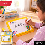 A young girl with dark hair writes “ABC” on a yellow-framed Pexon writing board with a white marker. A small yellow – view 2