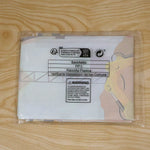A folded construction-themed birthday banner sealed in a clear plastic bag with recycling information and a warning label.