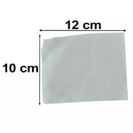 An arrangement of white adhesive sheets and black foot pad sachets laid out on a white background.