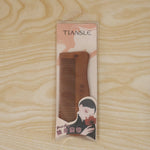 Beautiful wooden comb in packaging, ideal gift for hair care enthusiasts