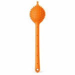 A single orange silicone back scrubber with a long handle and textured head is centered on a white background.