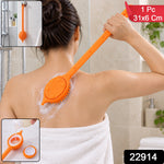 A person uses an orange silicone back scrubber with a soap dispenser on their back, with product details.