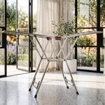 Foldable clothes drying rack on light background