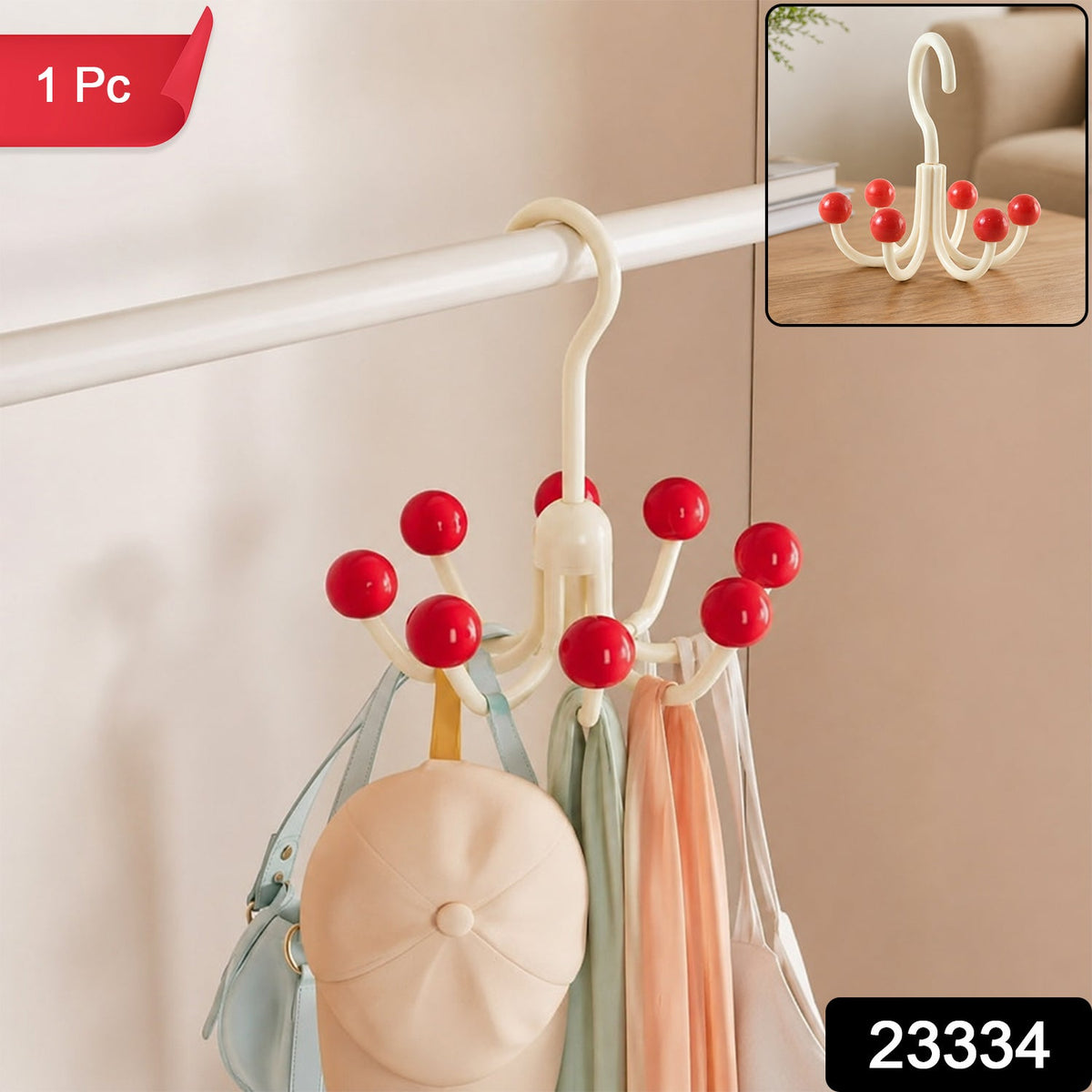 A cream multi-hook hanger with red ball tips, holding a light blue bag, a beige cap, and two scarves, hanging on a white