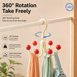 A cream multi-hook hanger with red ball tips, holding two scarves and a light blue bag, hanging on a white rod, with text