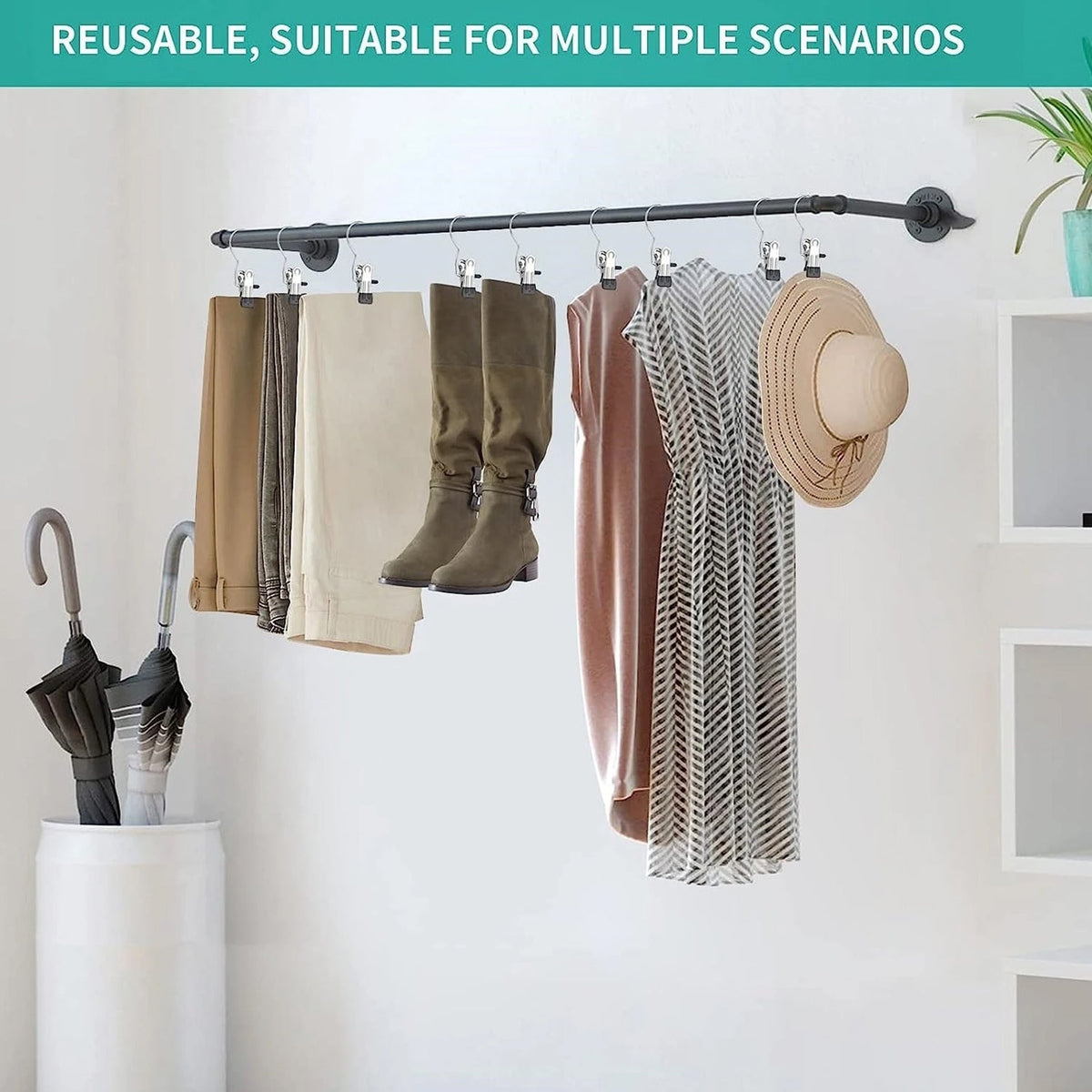 Multiple metal clip hangers are suspended from a black rod, holding various clothing items like pants, boots, a dress, and a