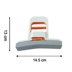 A hand squeezes the white and orange mini sponge mop over a stainless steel sink, demonstrating its water-squeezing function.