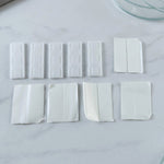 Plastic holder clips with adhesive pads